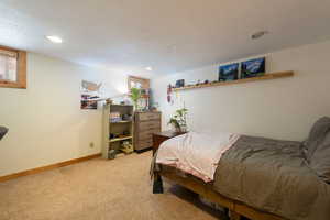 Bedroom featuring light carpet and recessed lighting