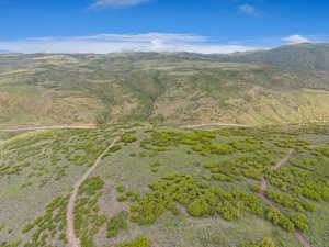 Aerial overview of property's location featuring a mountain backdrop