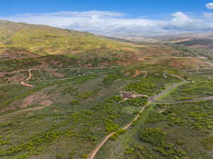 Aerial view of property and surrounding area with mountains
