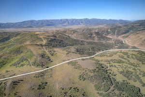 Aerial view of property's location with property parcel outlined and a mountain backdrop