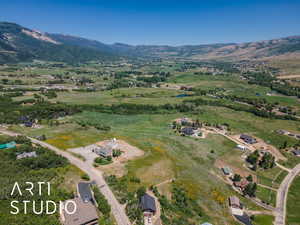 Aerial view of property's location featuring a mountainous background and rural landscape
