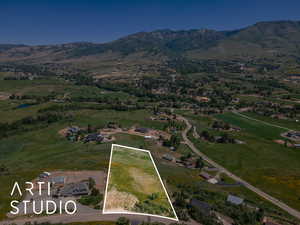 Aerial view of property's location featuring a mountain backdrop and property boundaries highlighted