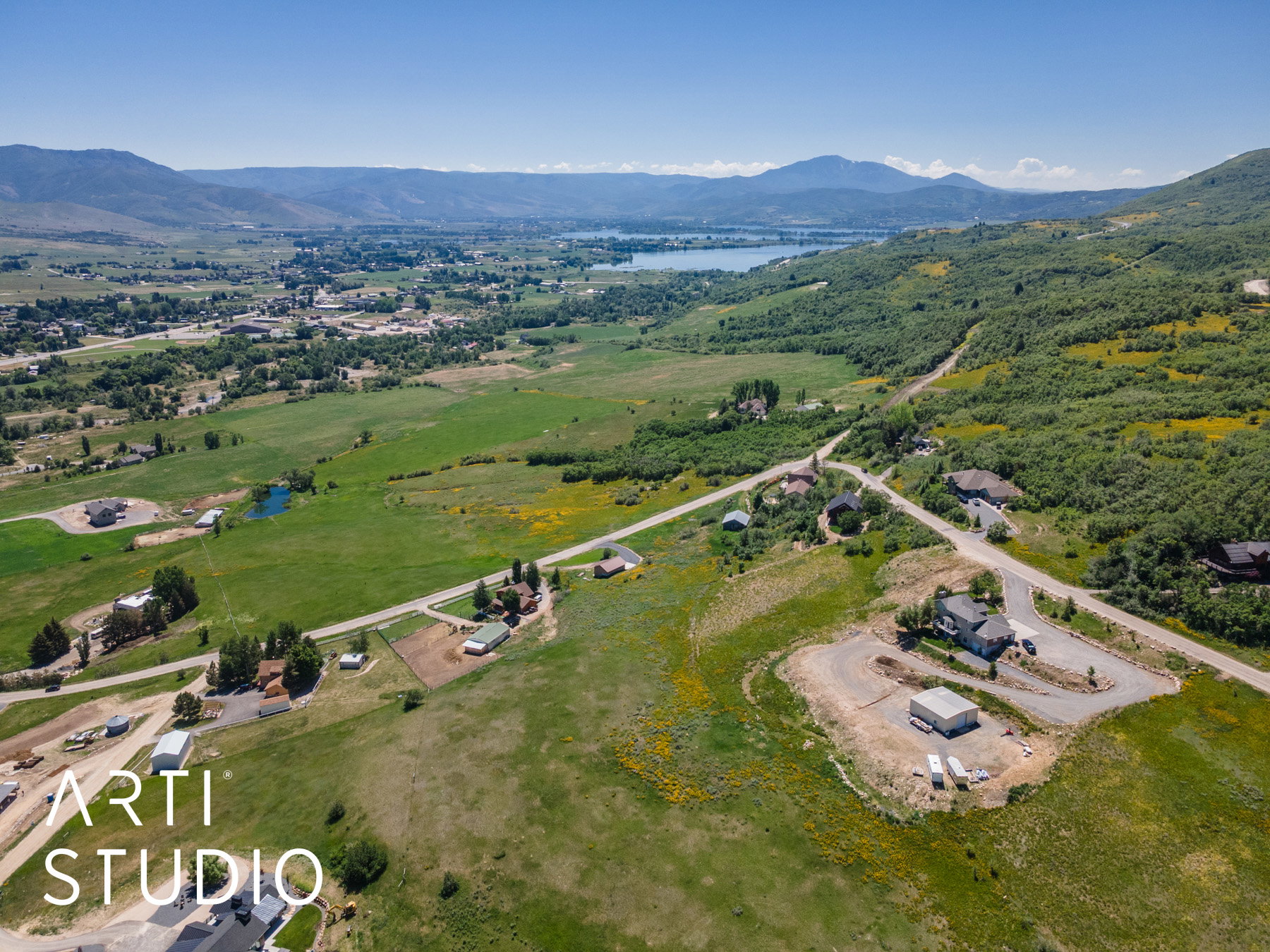 Aerial view of property and surrounding area featuring a water and mountain view