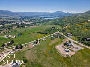 Aerial view of property and surrounding area featuring a water and mountain view