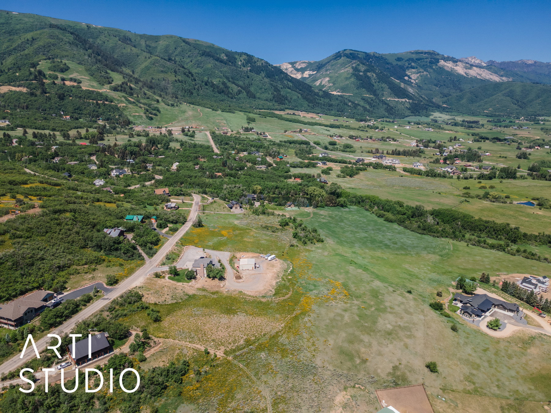 Aerial view of property and surrounding area with a mountainous background