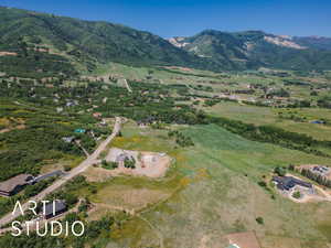 Aerial view of property and surrounding area with a mountainous background