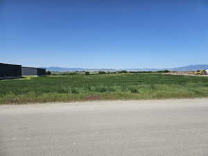 View of asphalt street with a mountain view and a view of rural / pastoral area