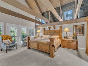 Bedroom with a wooden ceiling with exposed beams, access to exterior, light carpet, and high vaulted ceiling