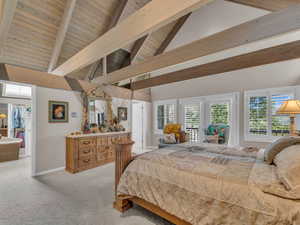 Carpeted bedroom featuring a wood ceiling with exposed beams, high vaulted ceiling, and access to exterior