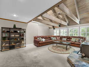 Carpeted living room with a ceiling fan and wooden ceiling