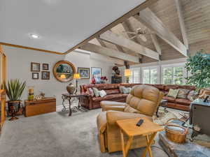 Living area with light colored carpet, a ceiling fan, beam ceiling, and recessed lighting