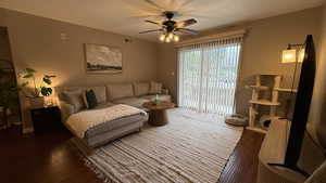 Living room with a ceiling fan and wood finished floors