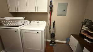 Laundry area with electric panel, washer and dryer, and cabinet space