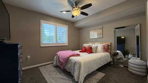 Bedroom with dark carpet and ceiling fan