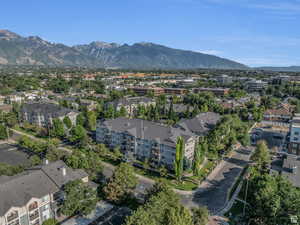 Aerial view of property and surrounding area with a mountain backdrop