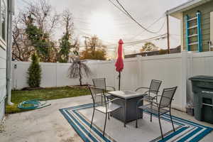 Fenced backyard featuring a patio area and an outdoor fire pit