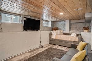 Living room with wooden ceiling and wood finished floors