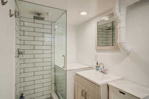 Full bath with a stall shower and vanity