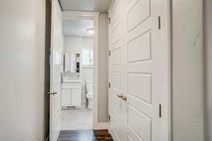 Bathroom with a textured ceiling, vanity, and wood finished floors