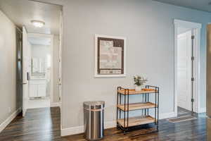 Corridor featuring dark wood-type flooring