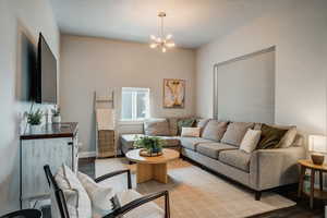 Living area with light wood-style floors and a chandelier