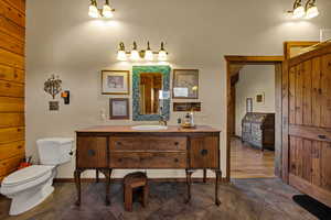 Primary bathroom with toilet and vanity
