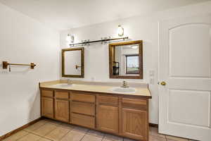 Bathroom featuring tile patterned flooring and double vanity