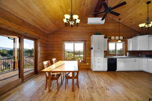 Dining room featuring vaulted ceiling, a chandelier, wooden ceiling, healthy amount of natural light, and a wall mounted air conditioner