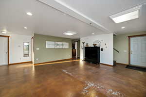 Unfurnished living room featuring finished concrete floors and recessed lighting