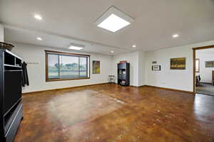 Unfurnished living room featuring concrete floors and recessed lighting