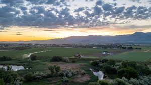View of mountain background featuring a nearby body of water and rural landscape