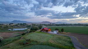 View of mountain backdrop featuring rural landscape and a nearby body of water
