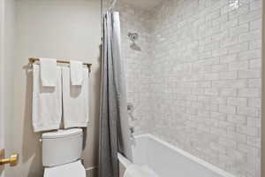 Bathroom with toilet and shower / tub combo