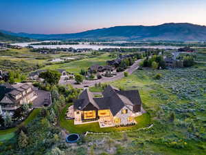 Aerial view of property and surrounding area featuring a water and mountain view