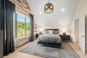 Bedroom featuring vaulted ceiling