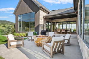 View of patio / terrace featuring grilling area, a mountain view, and an outdoor living space with a fire pit