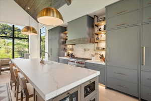 Kitchen with open shelves, wood ceiling, backsplash, wall chimney range hood, and high vaulted ceiling