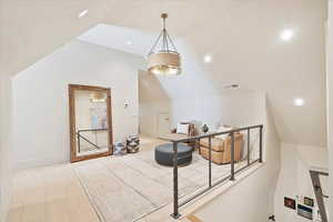Additional living space featuring lofted ceiling and recessed lighting