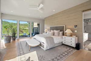 Bedroom featuring wood walls, wood finished floors, recessed lighting, access to outside, and ceiling fan