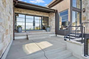 Property entrance featuring stone siding and french doors