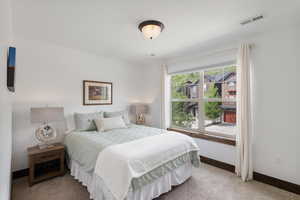 Bedroom featuring baseboards and light colored carpet