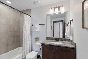 Bathroom with vanity and shower / tub combo with curtain
