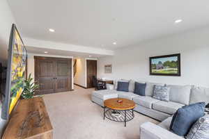 Carpeted living room featuring recessed lighting