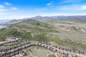 View of mountain backdrop featuring nearby suburban area