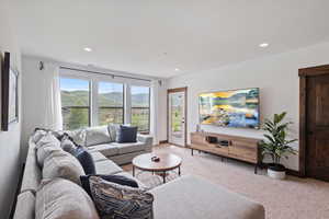 Living room with light carpet and recessed lighting