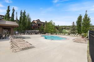 Community pool featuring a patio