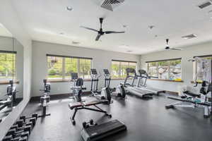 Exercise room featuring ceiling fan, a textured ceiling, and recessed lighting