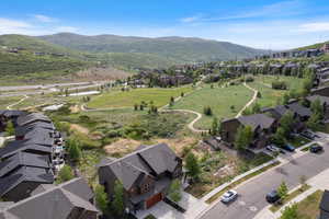 Aerial view of property's location featuring nearby suburban area and a mountainous background