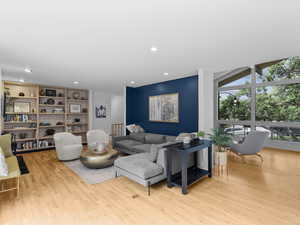 Living area with wood finished floors and recessed lighting