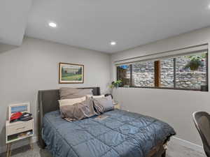 Carpeted bedroom with recessed lighting